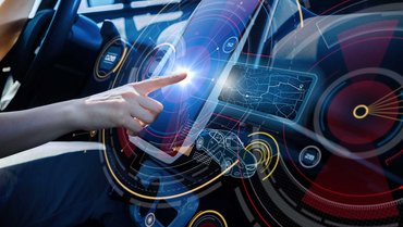 Hand touches futuristic display in a car