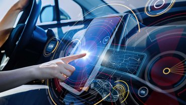 Hand touches futuristic display in a car