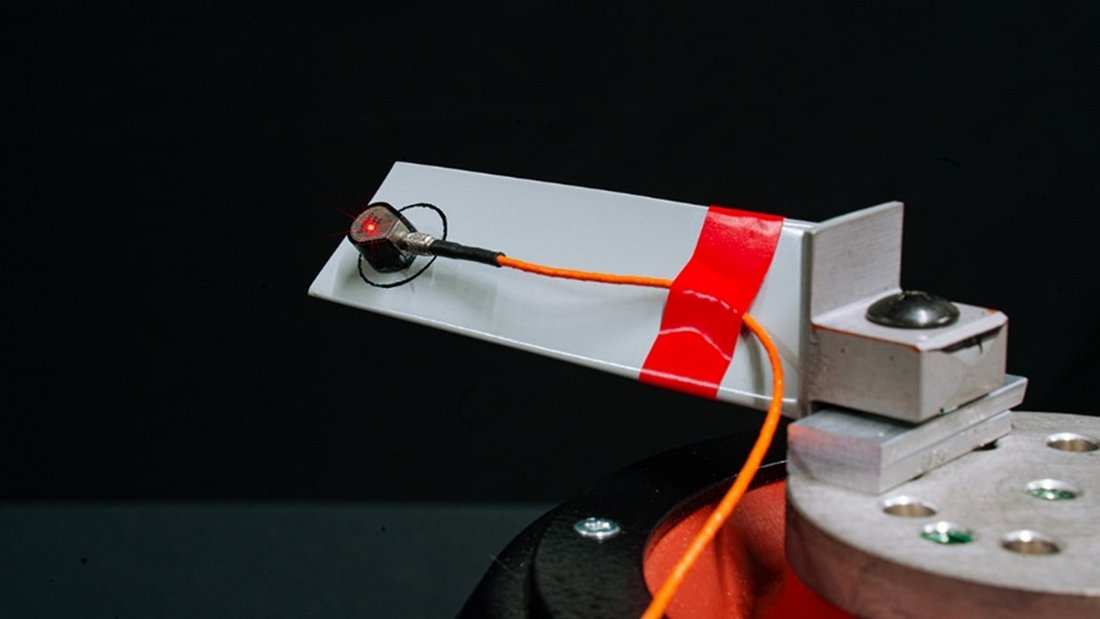 Turbine blade with an accelerometer attached to the tip. The laser’s light on the accelerometer shows that the VibroGo® (laser vibrometer) was measuring the accelerations of the turbine blade simultaneously.